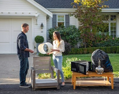 couple putting bulk waste at curb