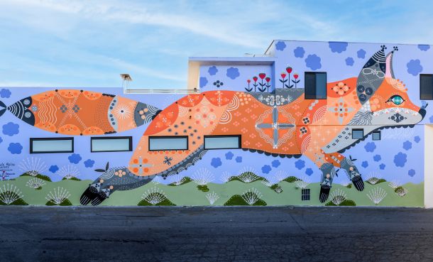 Orange and blue fox mural on wall