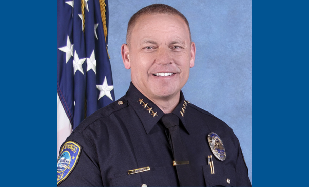 ESPD Police Chief Saul Rodriguez in front of American flag