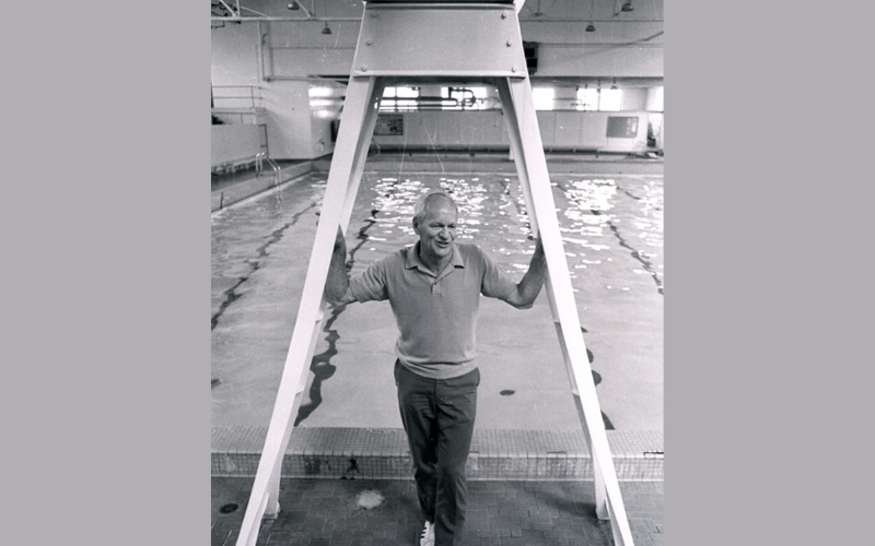 Urho Saari standing in front of pool in black and white photo