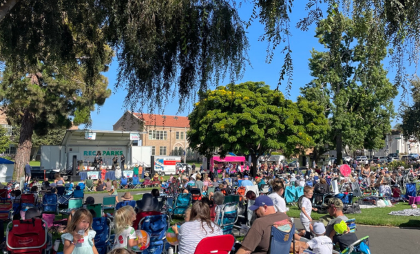 Summer Concert group in the park facing stage