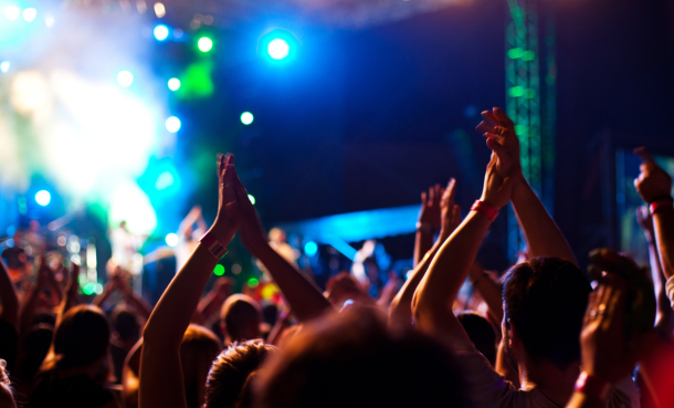 People at a concert at night dancing