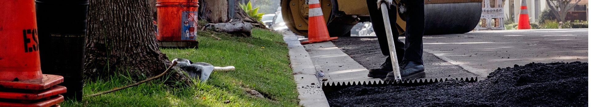 Man spreading asphalt on street