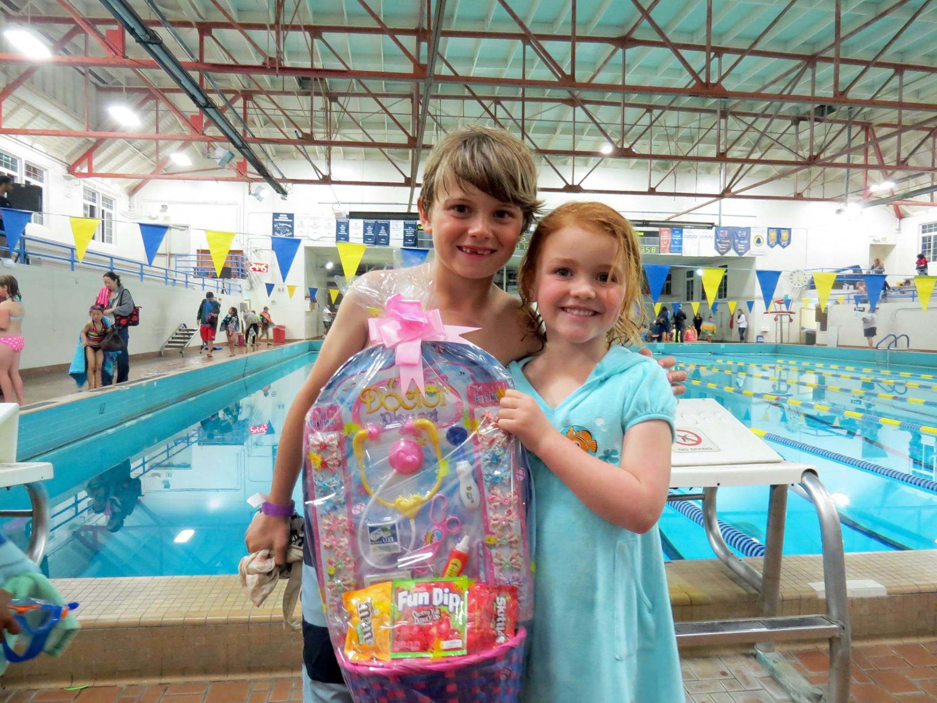 kids holding an Easter basket at the plunge aquatic center